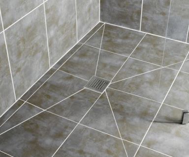 Tiled wet room floor with square stainless steel waste gully